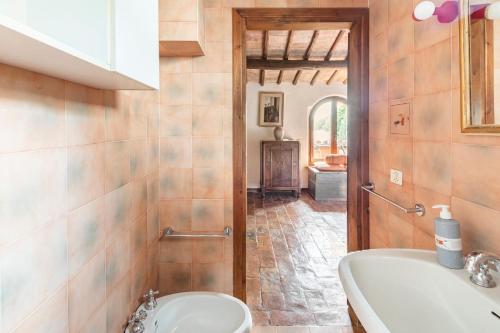 a bathroom with a toilet and a sink and a tub at Sunset and lake in Bolsena