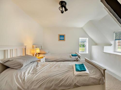 a bedroom with two beds and a window at 6 Bed in Taunton oc-95371 in Bicknoller