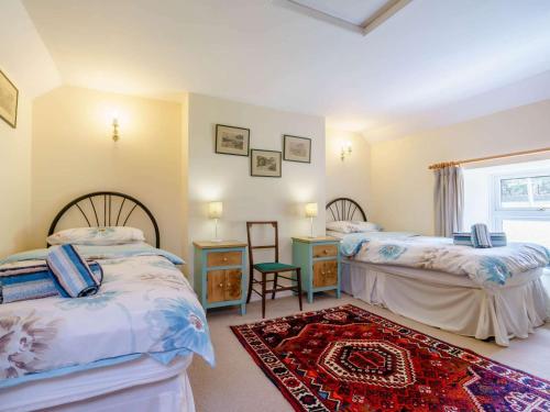 a bedroom with two beds and a rug at 3 Bed in Consett oc-cn195 in Hunstanworth