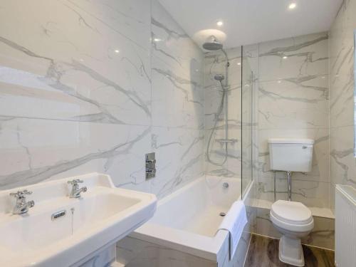 a bathroom with a sink and a tub and a toilet at 2 Bed in Barnoldswick oc-83775 in Barnoldswick