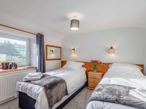 a bedroom with two beds and a window at 2 Bed in Barnoldswick oc-83775 in Barnoldswick