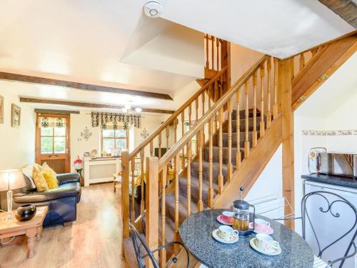 a living room with a staircase and a table at 2 Bed in Skipton oc-79093 in Skipton