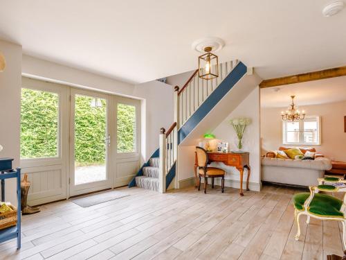 a living room with a staircase and a table at 3 Bed in Ilminster oc-77987 in Cudworth