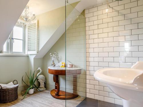a bathroom with a sink and a bath tub at 3 Bed in Ilminster oc-77987 in Cudworth