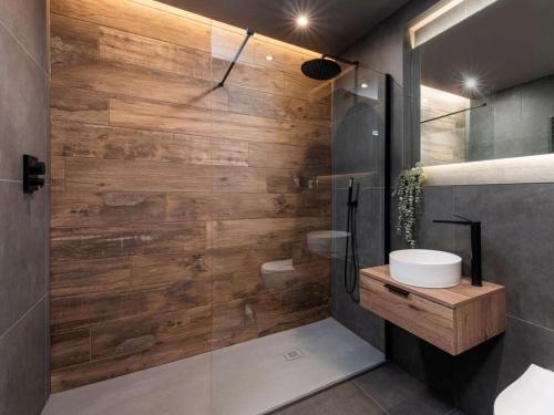 a bathroom with a shower with a wooden wall at 4 Bed in Morpeth oc-95889 in Amble