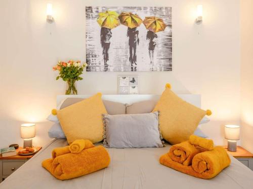 a couch with two stuffed animals on it with umbrellas at 2 Bed in Skipton oc-87370 in Kettlewell