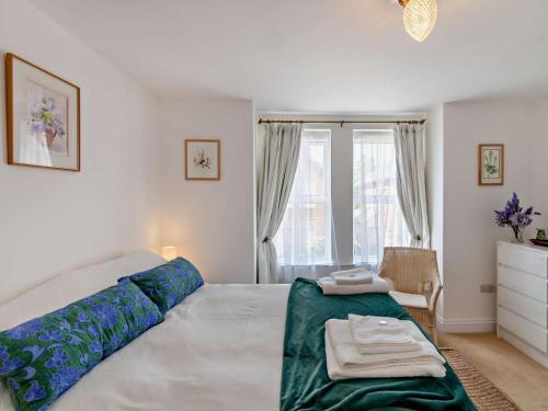 a bedroom with a large bed and a window at 2 Bed in Bembridge oc-94115 in Bembridge