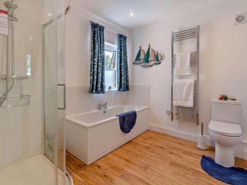 a bathroom with a sink and a toilet and a shower at 2 Bed in Bembridge oc-94115 in Bembridge