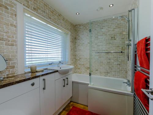 a bathroom with a sink and a shower and a tub at 3 Bed in Wooler oc-93544 in Wooler