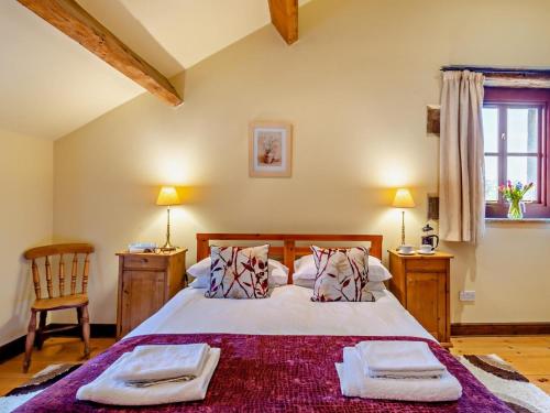 a bedroom with a large bed with two towels on it at 3 Bed in Skipton oc-94259 in Airton
