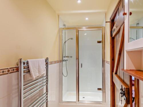 a bathroom with a shower with a glass door at 3 Bed in Skipton oc-94259 in Airton