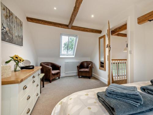 a bedroom with a bed and a desk and chairs at 3 Bed in Salisbury oc-66130 in Redlynch