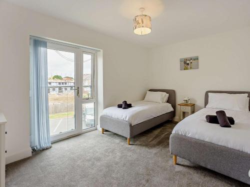 a bedroom with two beds and a window at 2 Bed in Sandown oc-83617 in Sandown