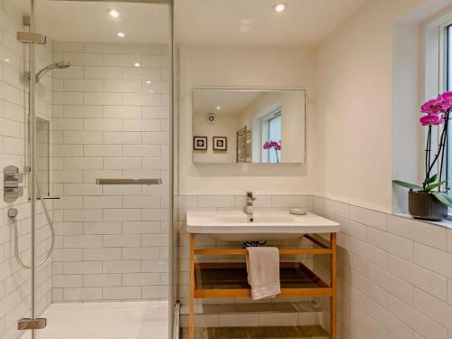 a bathroom with a sink and a shower at 3 Bed in Brockenhurst oc-47431 in Beaulieu
