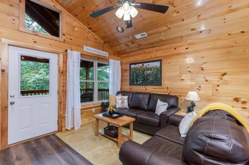 a living room with a couch and a ceiling fan at Prime Location & Loaded For Family Fun in Pigeon Forge