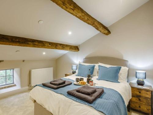 a bedroom with a large bed with two towels on it at 4 Bed in Skipton oc-84017 in Rylstone