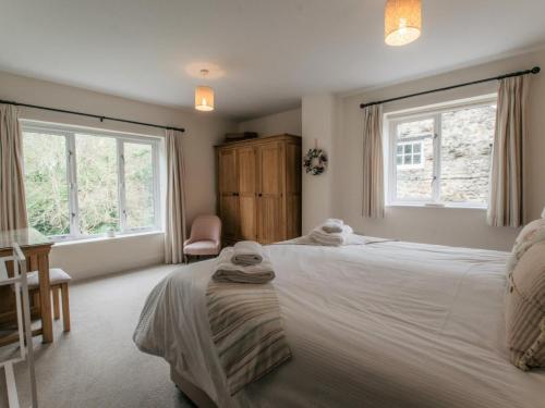 a bedroom with two beds and two windows at 3 Bed in Bedale oc-g0095 in Crakehall