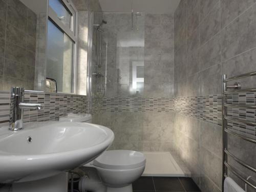 a bathroom with a sink and a toilet at 2 Bed in Kewstoke oc-57144 in Weston-super-Mare
