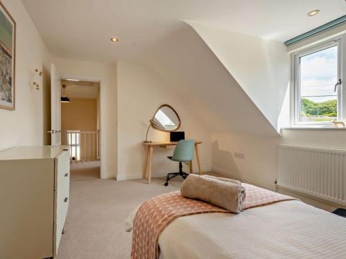 a bedroom with a bed and a desk and a window at 4 Bed in Swanage oc-dc217 in Langton Matravers