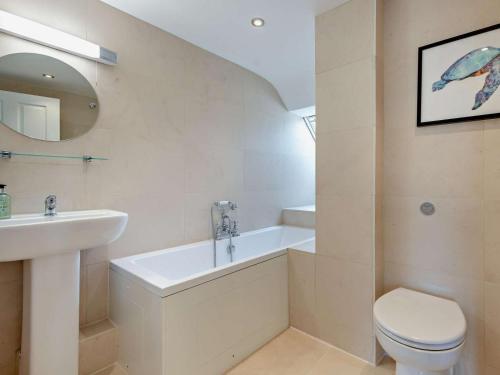 a white bathroom with a sink and a toilet at 4 Bed in Swanage oc-dc217 in Langton Matravers