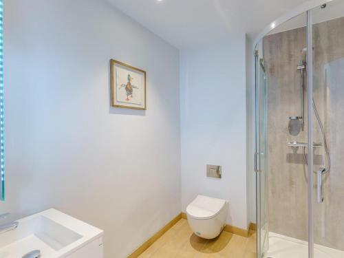 a bathroom with a toilet and a glass shower at 1 Bed in Brockenhurst oc-78730 in Brockenhurst