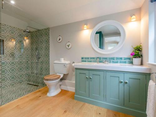 a bathroom with a toilet and a sink and a mirror at 1 Bed in Wincanton oc-83499 in Hilton