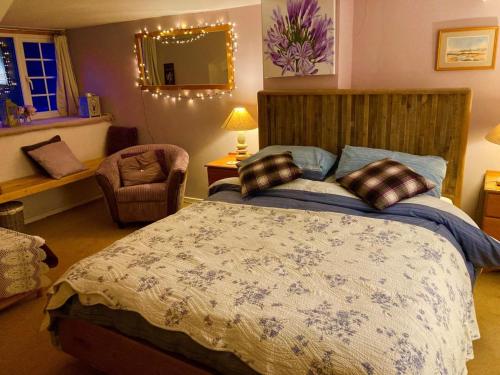 a bedroom with a bed and a chair and a mirror at 1 Bed in Hexham oc-89085 in Bellingham