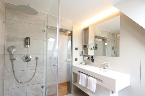 a bathroom with a shower and a sink at Hotel Goldenes Rad in Ulm