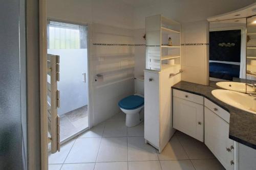 a bathroom with a toilet and a sink at Villa Repose by Villa Plus in Argeliers