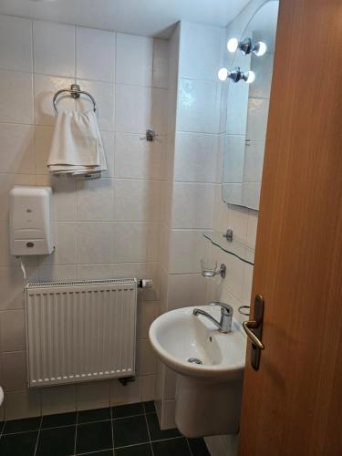 a bathroom with a sink and a mirror at Penzion Pupík in Modrava