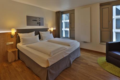 a bedroom with a large bed in a room at Hotel Goldenes Rad in Ulm