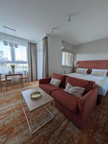 a hotel room with a couch and a bed at BelMare 327 Aqua in Międzyzdroje