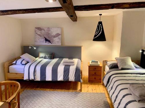 a bedroom with two beds and a pendant light at Landhaus Wahmbeck in Wahmbeck