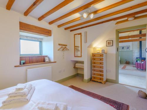 a bedroom with a white bed and a window at 2 Bed in Berwick -upon- Tweed oc-36344 in Kyloe