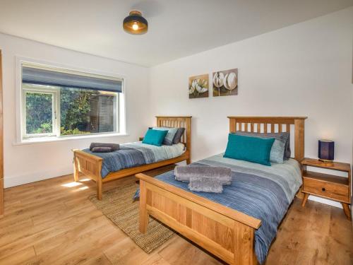 a bedroom with two beds and a window at 2 Bed in Lymington oc-87885 in Sway