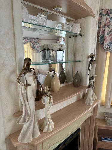 a shelf above a fireplace with vases on it at Luxury Caravan Coastfields Holiday Village in Ingoldmells