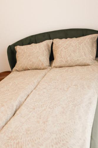 a bed with two pillows on top of it at Haus Auf Bulz - Klippeneck in Denkingen