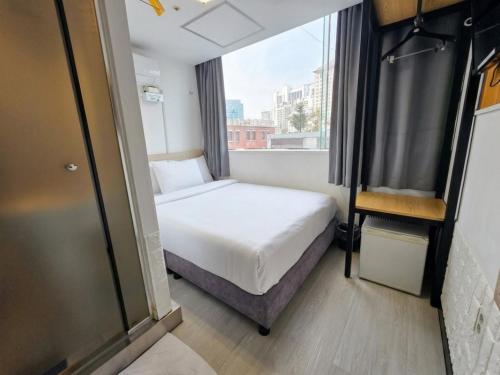 a small bedroom with a bed and a window at Ekonomy Hotel Myeongdong Premier in Seoul