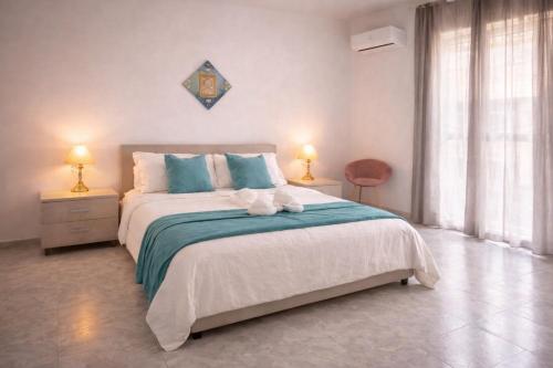a bedroom with a large bed with blue and white at Casa vacanza da Paola in Trapani