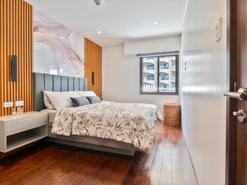 a bedroom with a bed and a window at Relaxing 1-Bedroom Resort Condo Unit at Tambuli Seaside Living, Mactan, Lapu-lapu City in Maribago