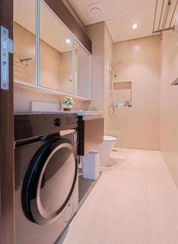 a bathroom with a washer and dryer in it at Relaxing 1-Bedroom Resort Condo Unit at Tambuli Seaside Living, Mactan, Lapu-lapu City in Maribago