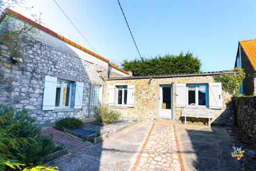 a stone house with a bench in front of it at Côte et Mer in Wissant