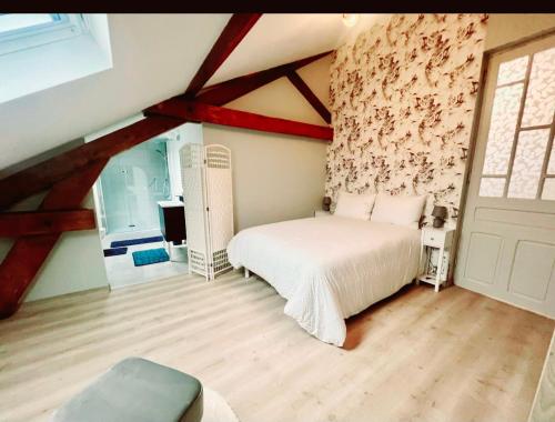 a bedroom with a bed in a room with a ceiling at Chambre avec Salle de Bain Privative in Tarbes