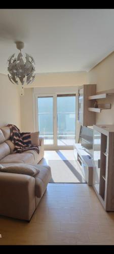 a living room with a couch and a table at Malpica I in Malpica