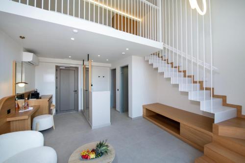 a living room with a staircase and a table at Ventale Island Breeze Resort in Georgioupolis