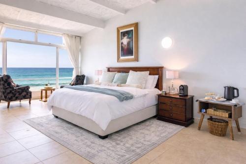 a bedroom with a bed and a view of the ocean at Sea View Luxury Penthouse in Ballito
