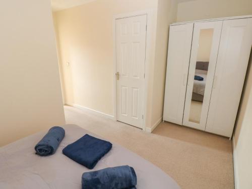 a bedroom with two blue pillows on a bed at Swansea Escape in Swansea