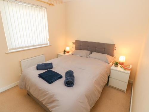 a bedroom with a large bed with two bags on it at Swansea Escape in Swansea
