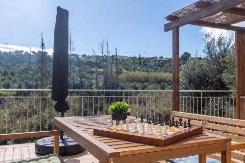 a wooden table with bottles on it on a deck at Sarantou House in Koroni