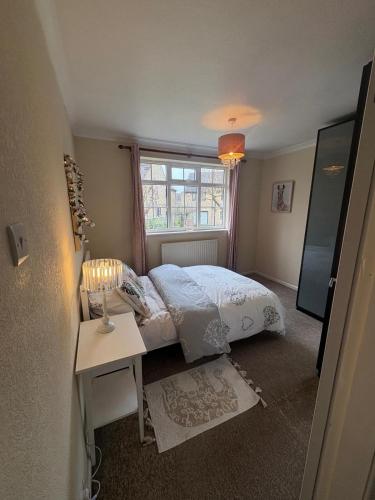 a small bedroom with a bed and a window at Westfields Bungalow in Mirfield